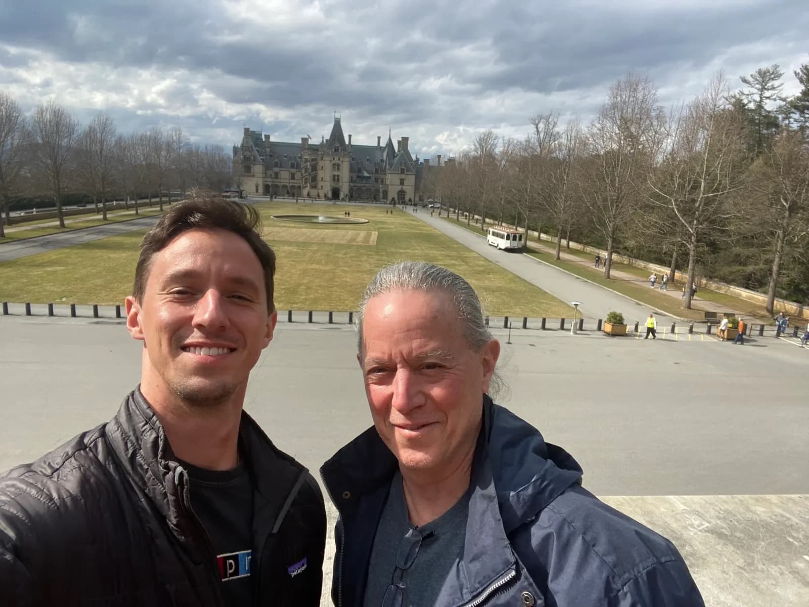 Dylan and a companion taking a selfie on the lawn in front of Biltmore House