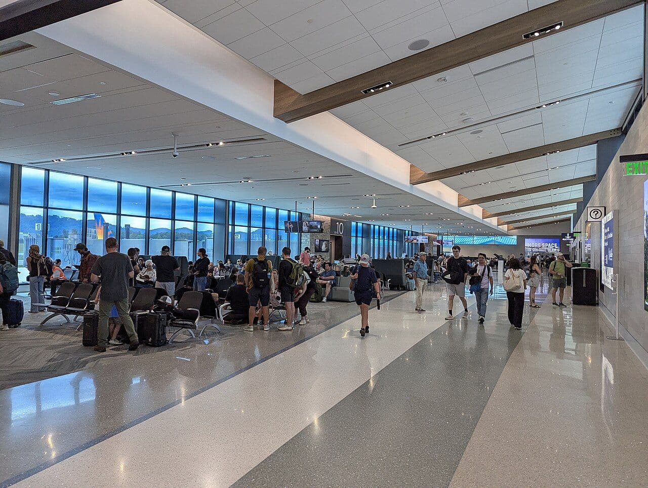 Bright, glass-walled gate area inside the Asheville Regional Airport terminal