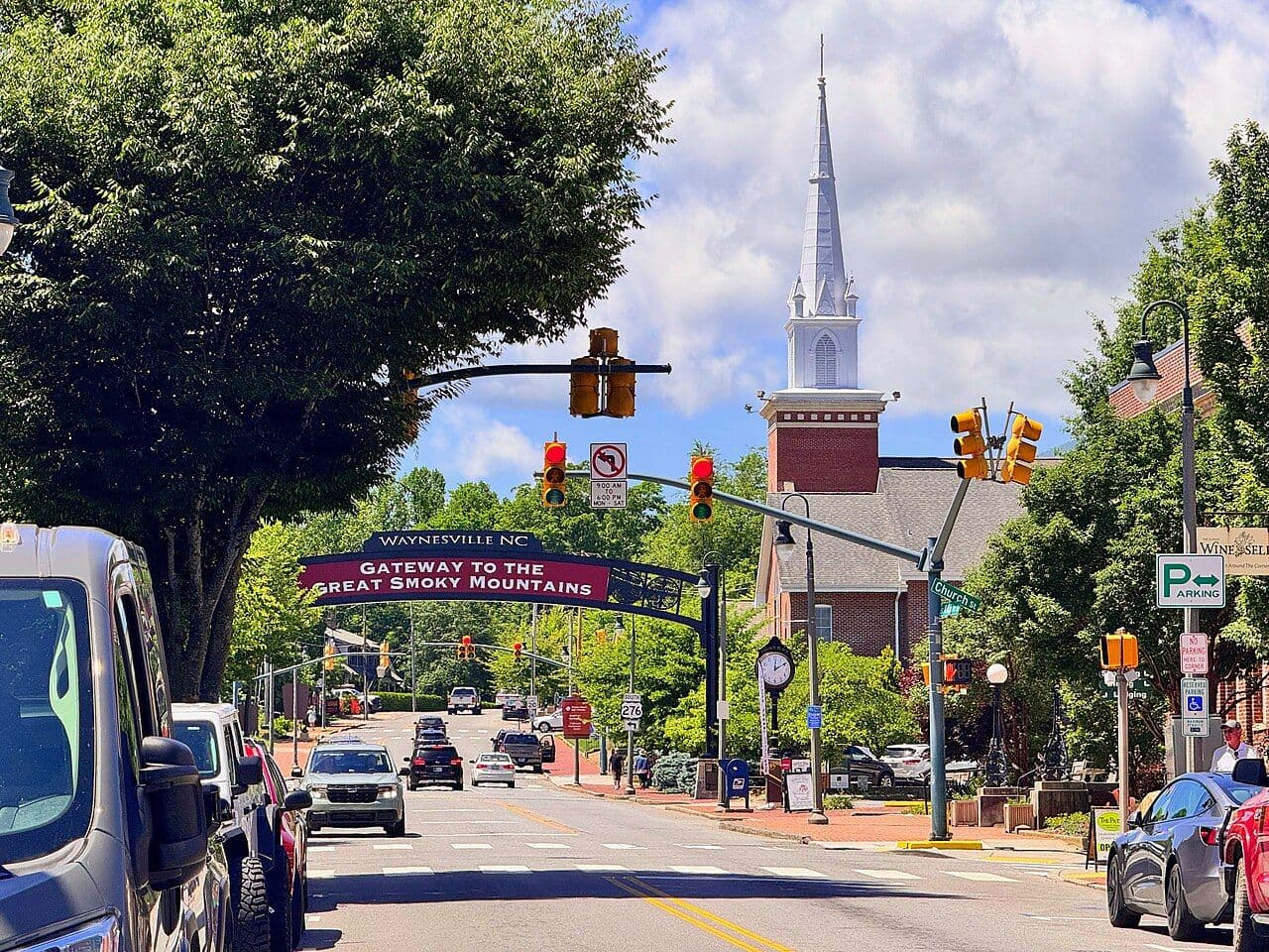 Downtown Waynesville's Main Street with a Gateway to the Great Smoky Mountains banner and a white church steeple