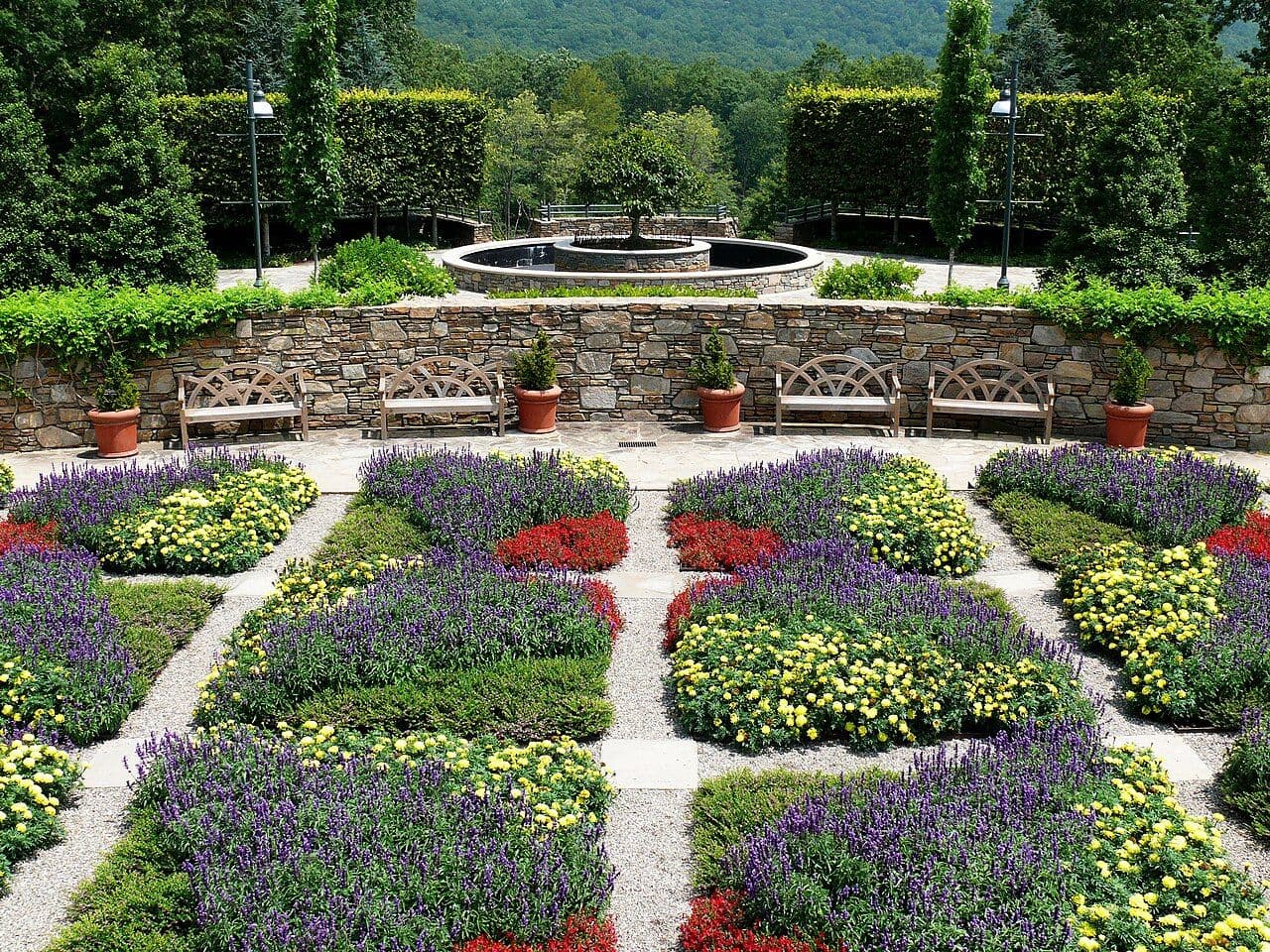 Quilt-pattern flower beds in bright purple, red and yellow at the North Carolina Arboretum