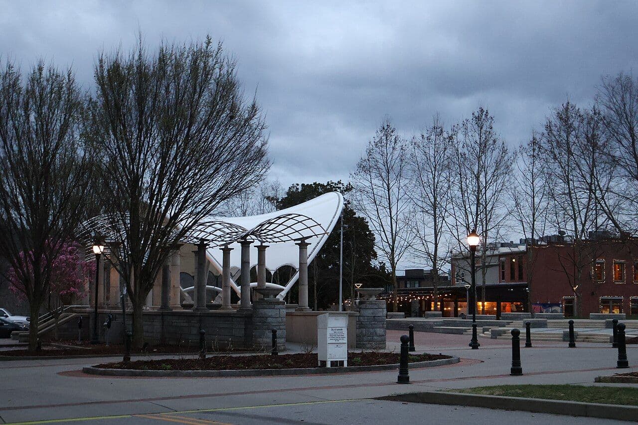 Pack Square Park in downtown Asheville with lawns, trees and a pavilion