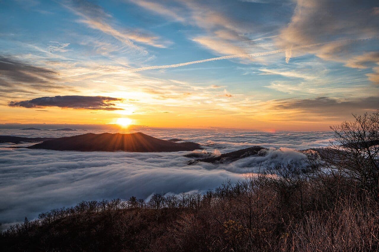 Sun rising over a sea of fog in the valleys below the Blue Ridge Parkway