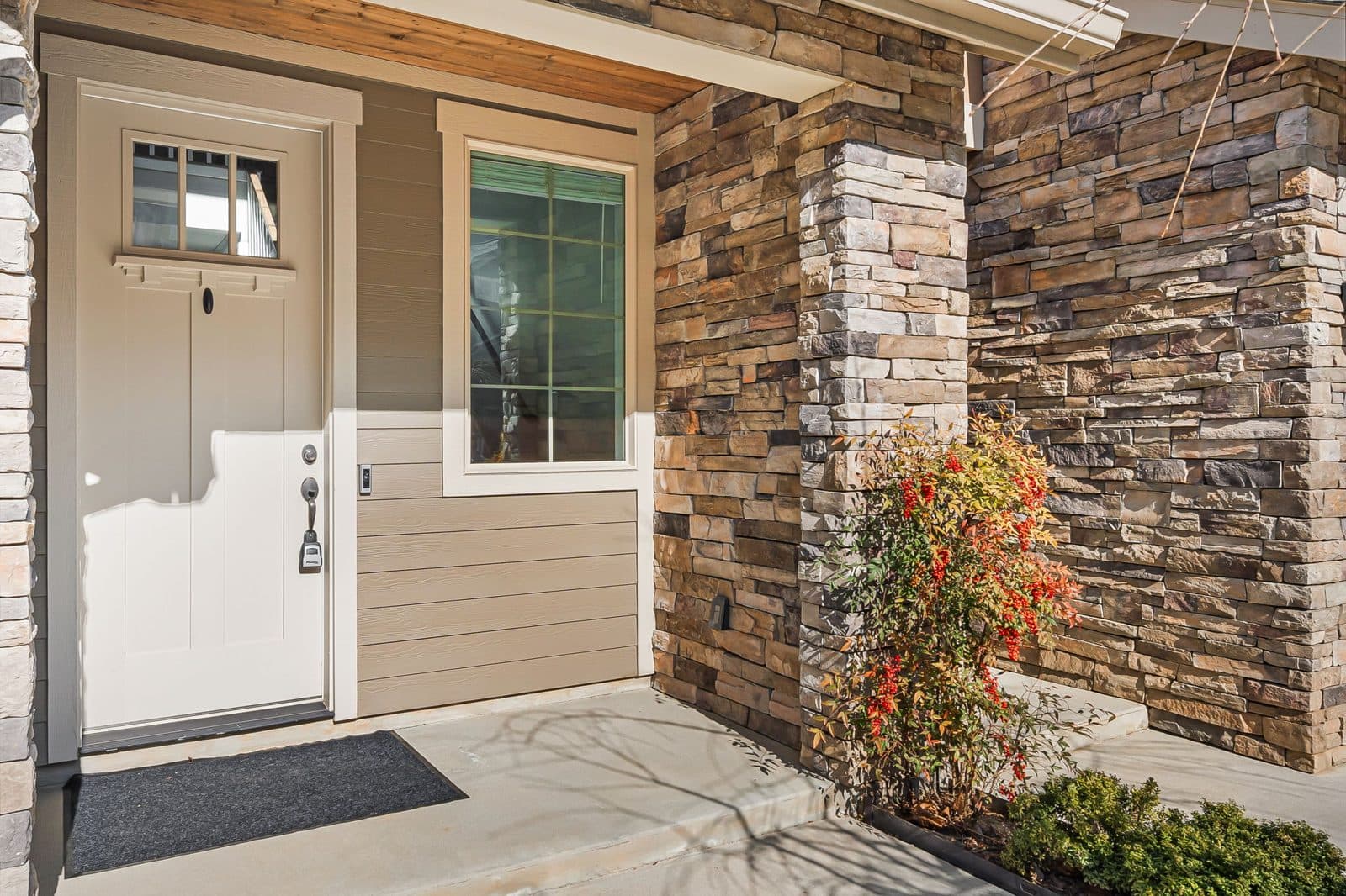 Covered front entry of a one-level home with a flat concrete walk and no steps up to the door
